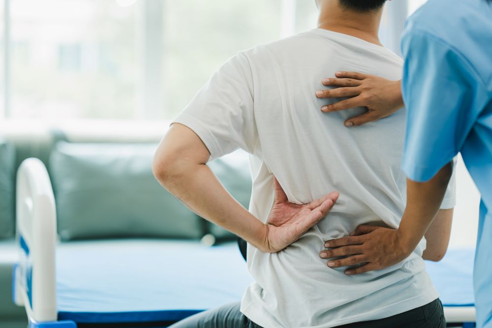 Patient with back pain receiving physical therapy